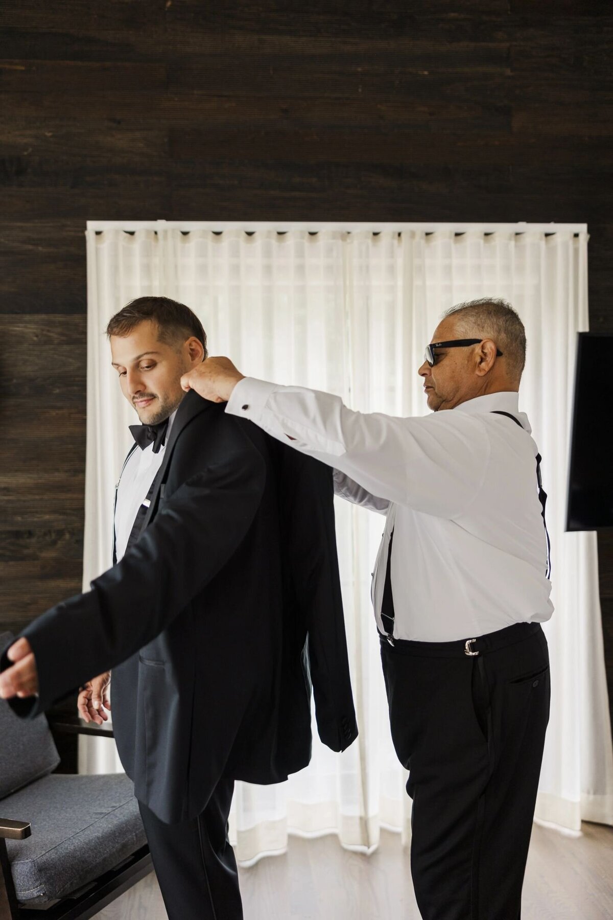 The groom gets ready in a hotel room at The Roundhouse in Beacon
