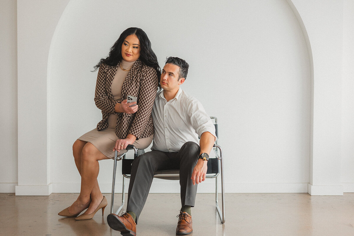 Two people look at a phone