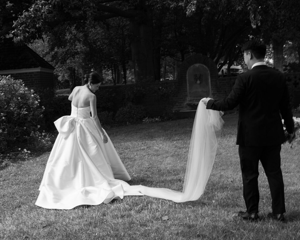 Bride and Groom in wedding suit and a long white dress posing for photo