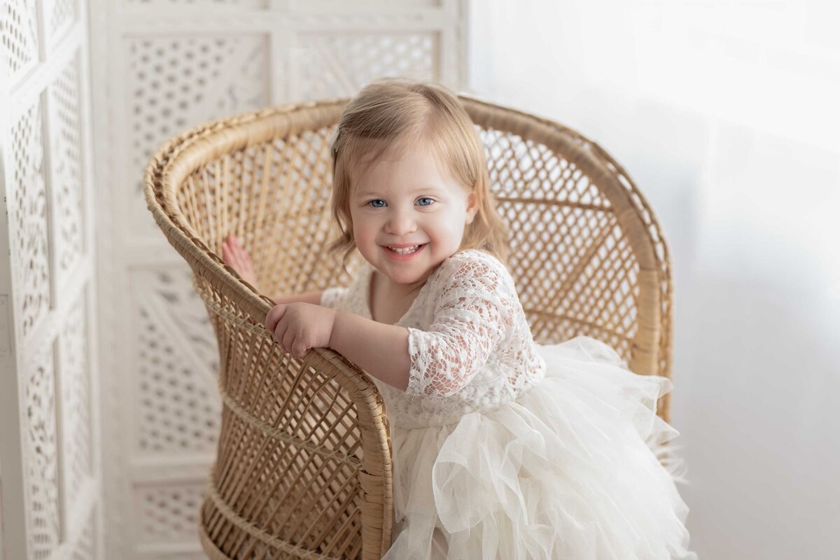 One Year Old  Baby Girl Smiling In White Dress