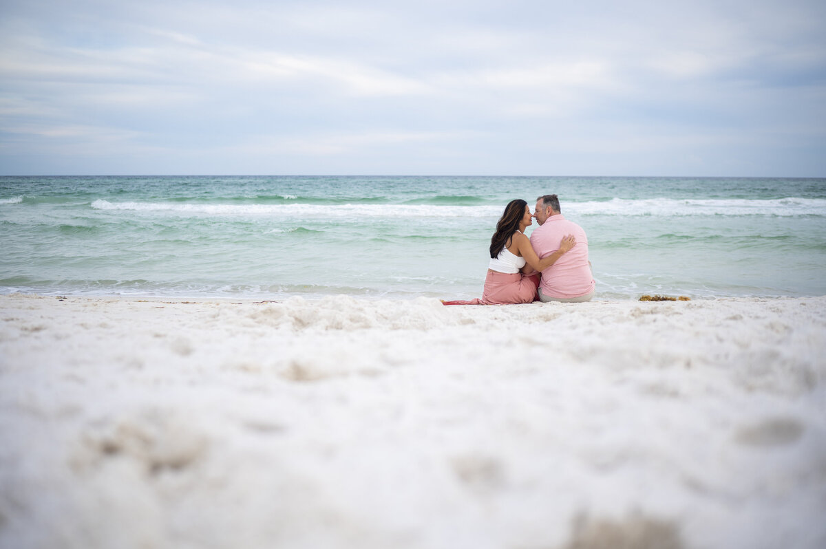 Newly engaged couple taking beach photos in Destin Florida
