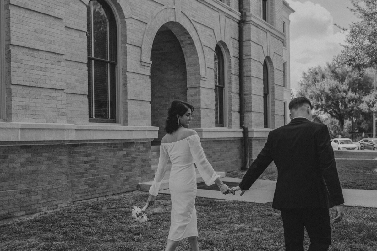 As a wedding photographer capturing an elopement at the courthouse in Houston, I witnessed the raw beauty of love in its simplest form. With the courthouse as their sanctuary, the couple exchanged vows in a ceremony filled with emotion and authenticity, creating a moment of profound intimacy and connection amidst the hustle and bustle of the city.