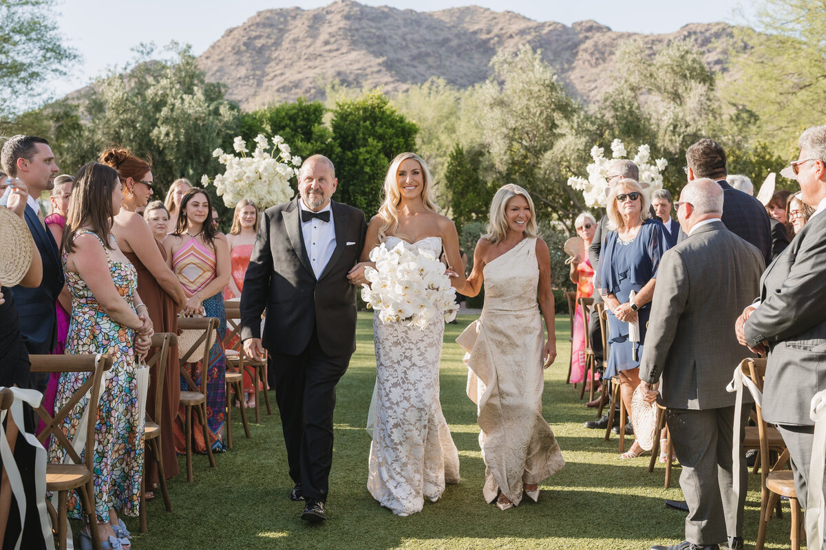 Bride walking down aisle with parents at El Chorro in Scottsdale, Arizona