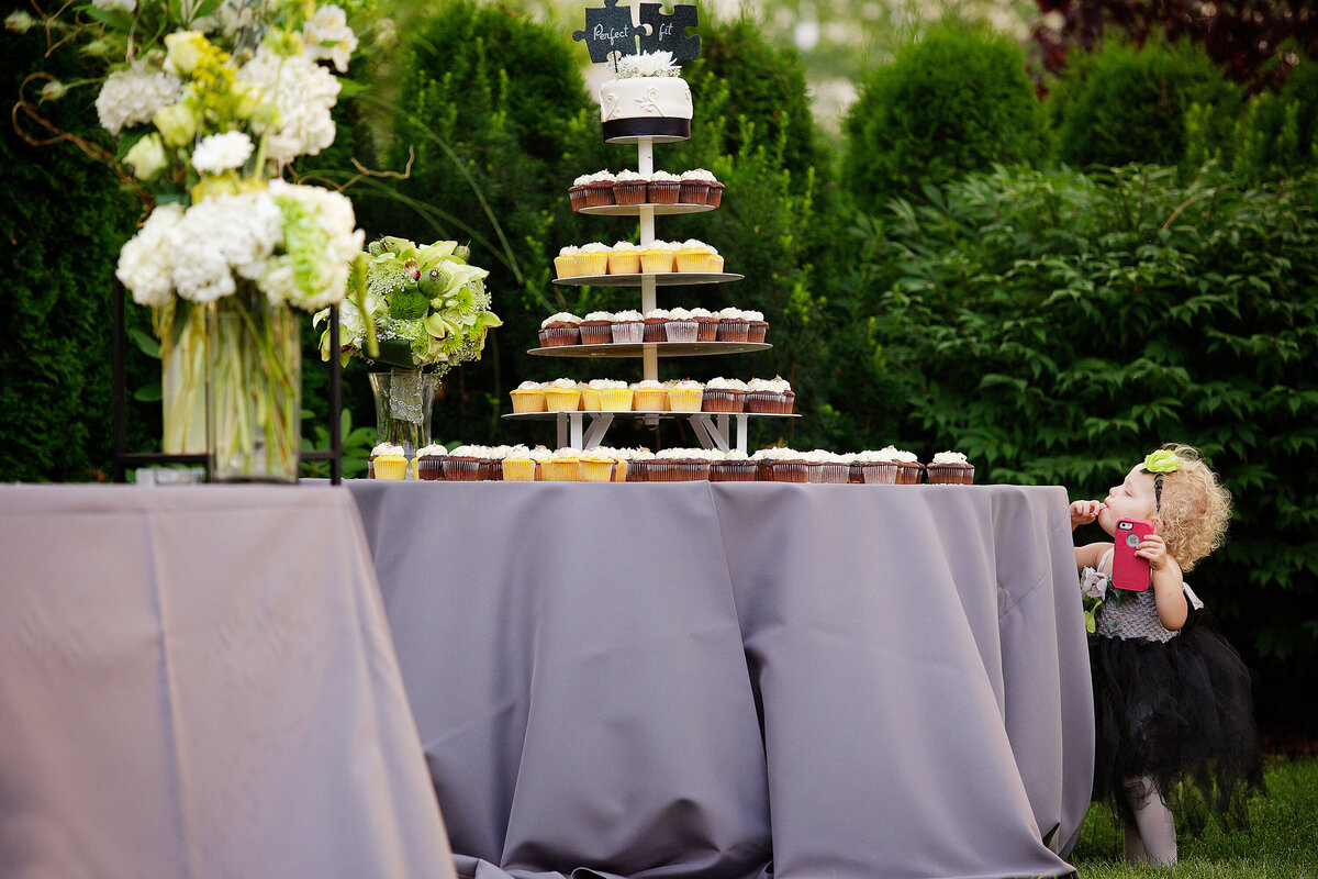 A young girl licks the frosting off her finger after reaching for a cupcake during the wedding ceremony at The Roosevelt Inn, in Coeur d'Alene, Idaho.