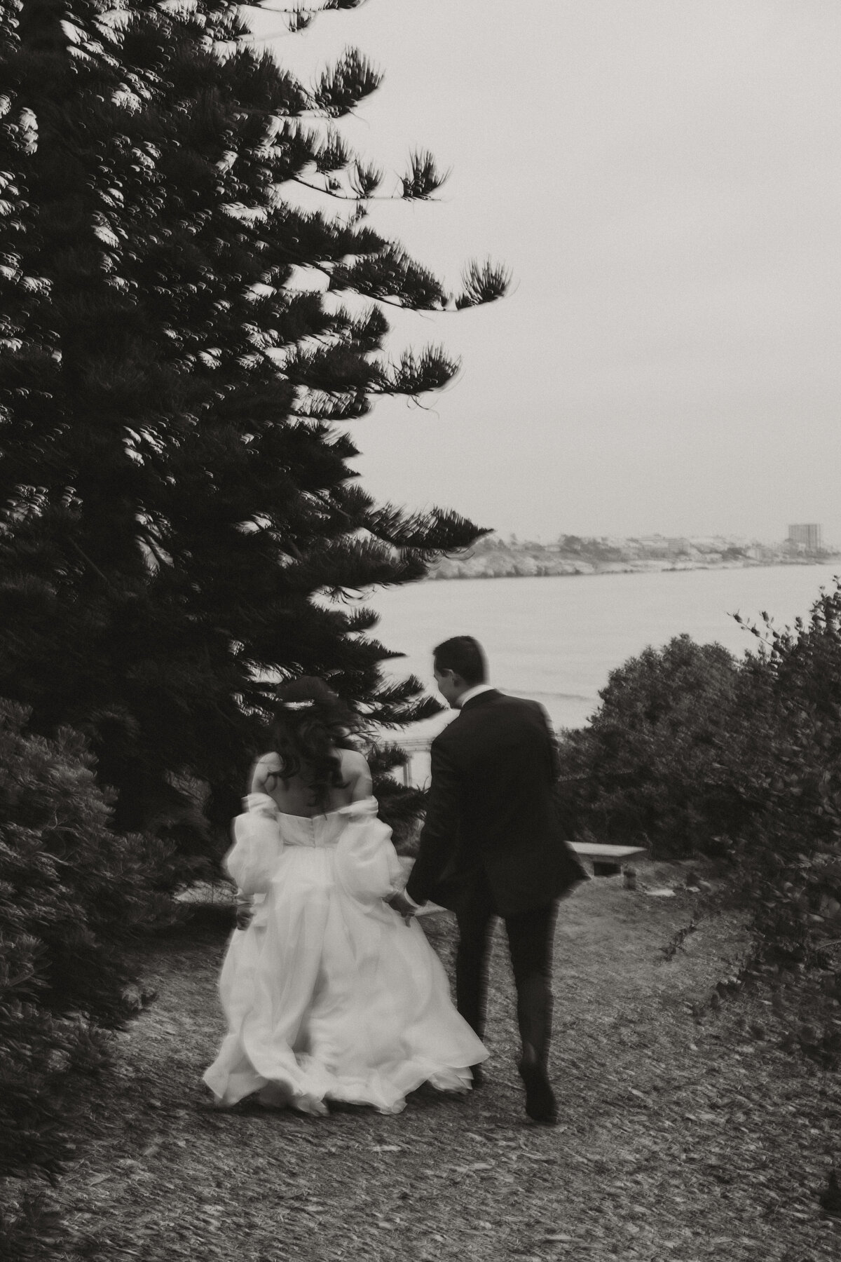 la jolla wedding, bride and groom running from camera, bride and groom black and white romantics