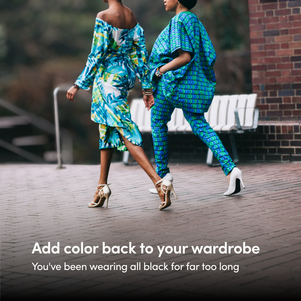 Two black women wearing a mixture of blue and green patterns in their stylish outfits walk away from the camera across bricks in high heels