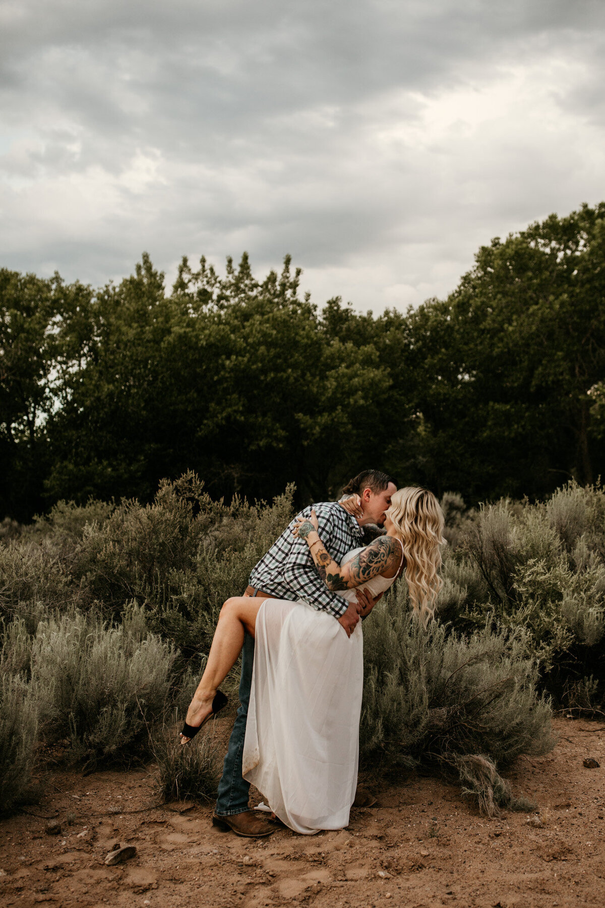 Bride and groom kissing in the desert