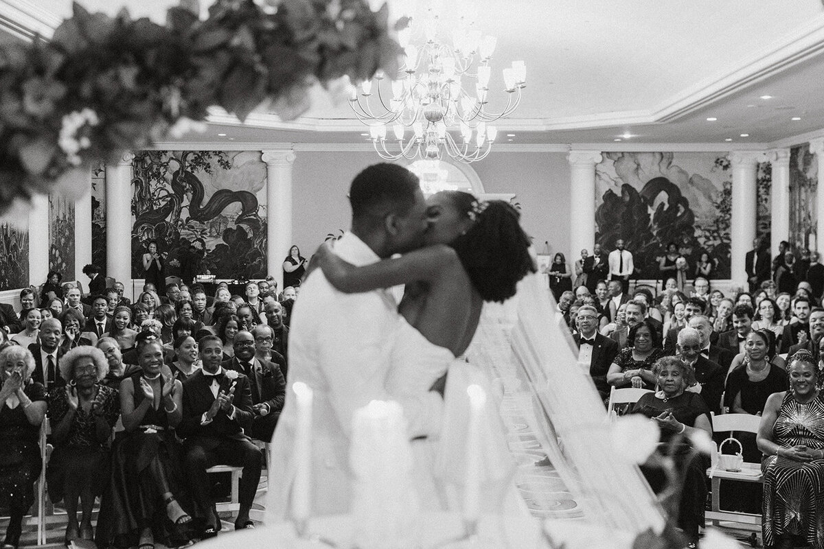 black couple kiss at wedding ceremony