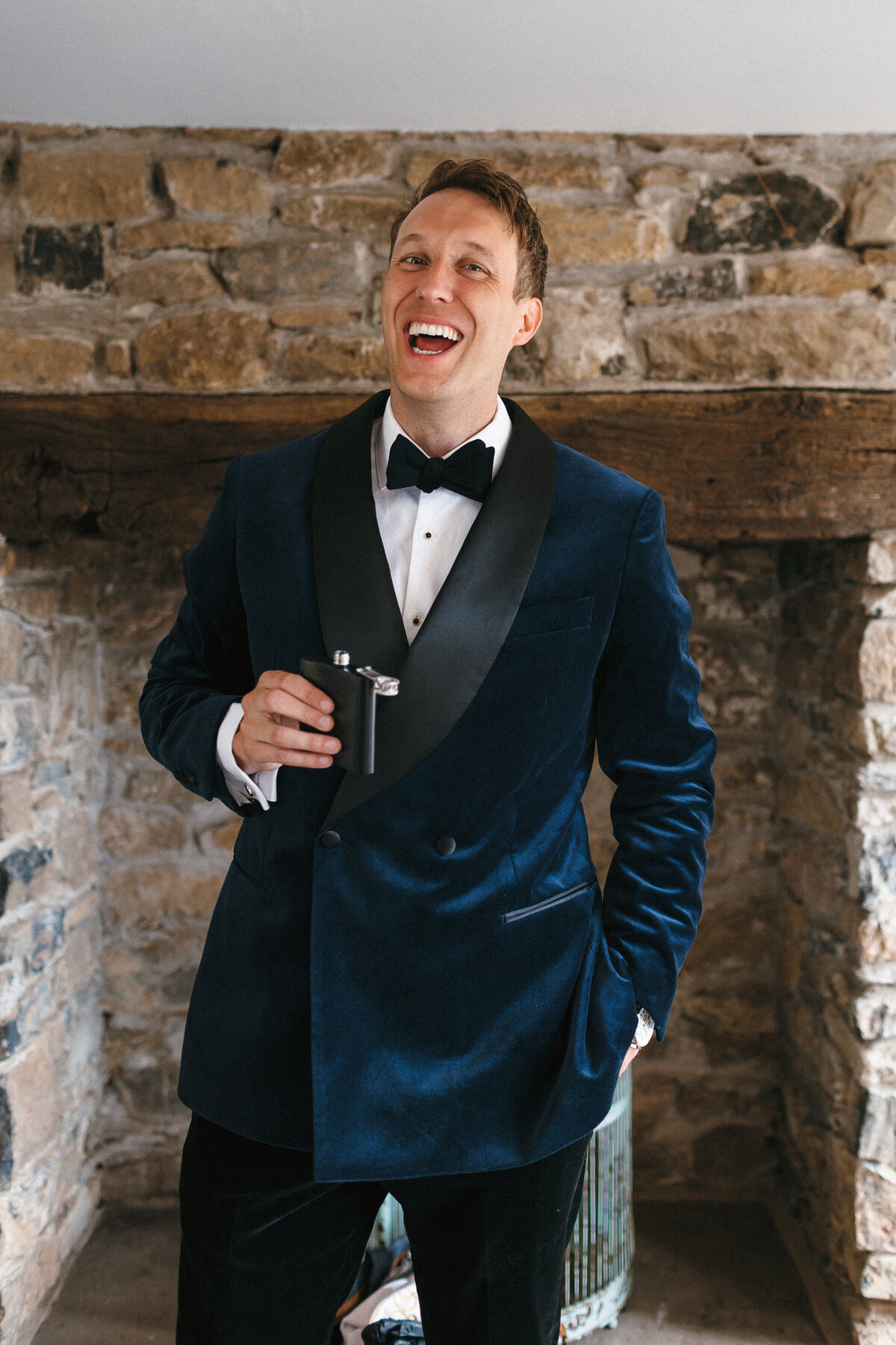 Groom wears navy velvet 