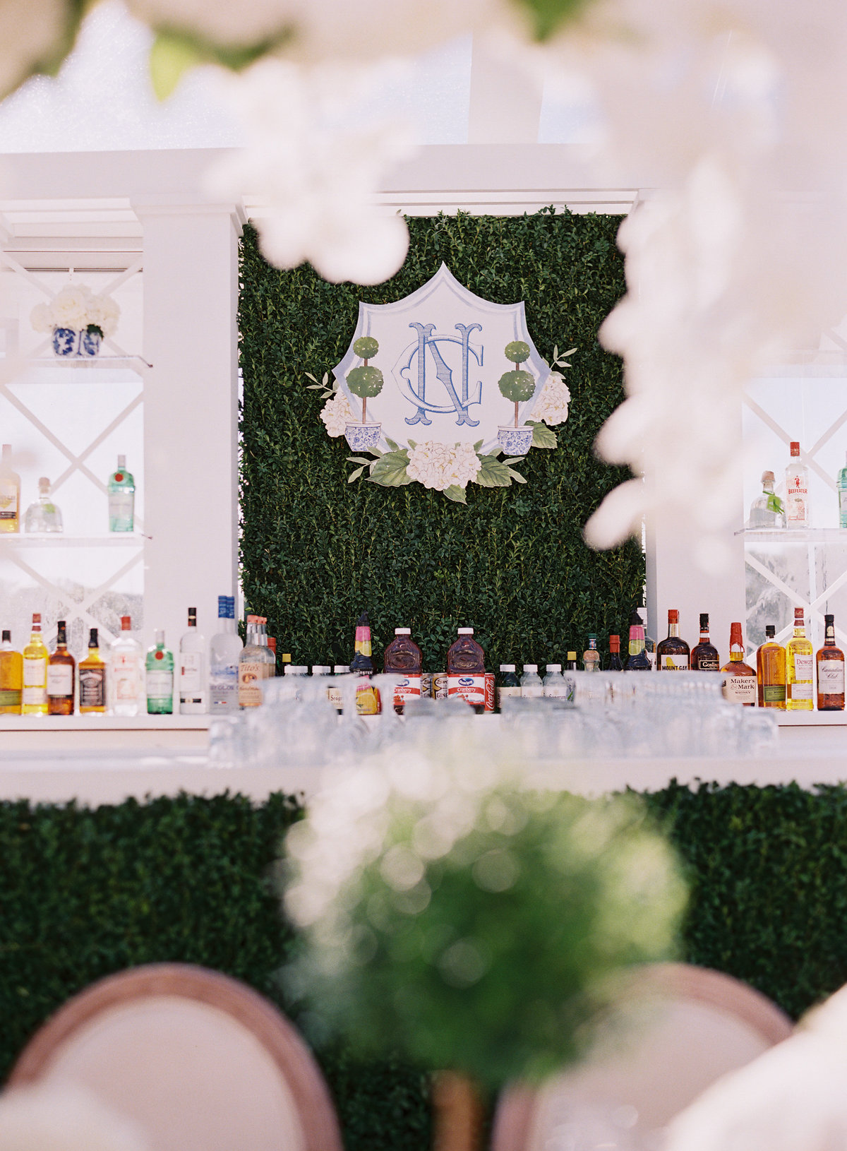 Picture of the bar at the wedding with the initials of the bride and groom on the wall. 