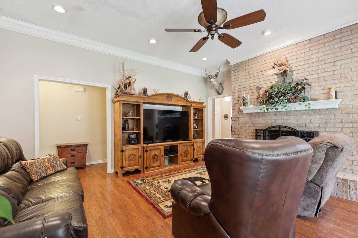 6419_shadow_lane_dallas_tx_living_room_with_fireplace_and_media_center_-_spacious_family_room_-_haven_realty_group