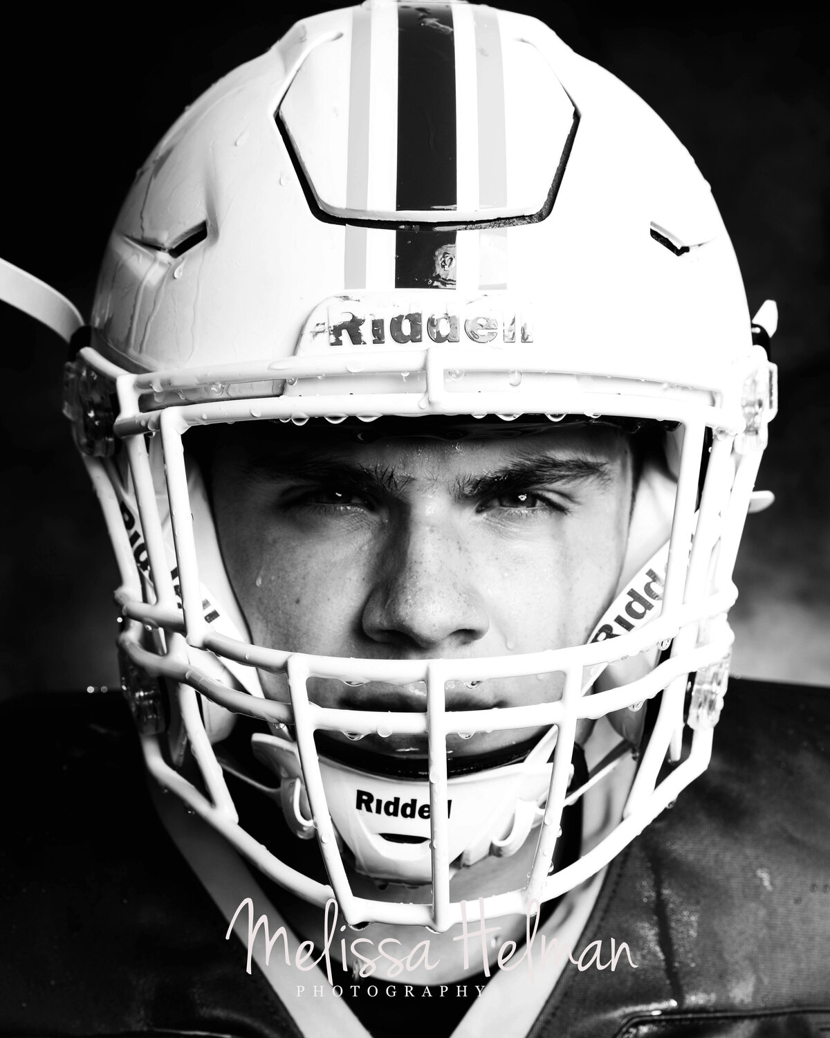 football player looking at camera in with helmet on for Greensburg portrait