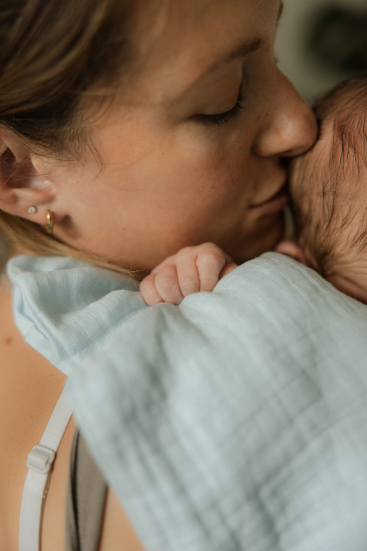 detail of mother kissing baby