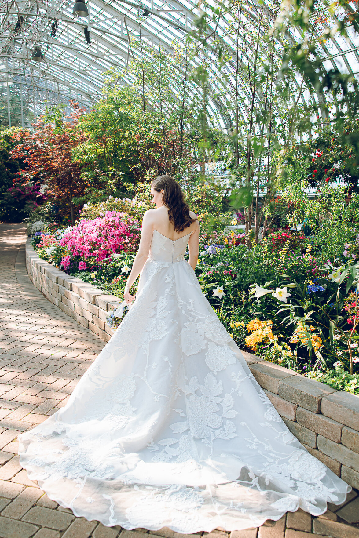 A bride poses in her wedding dress that she designed herself at the Garfield Park Conservatory in Chicago