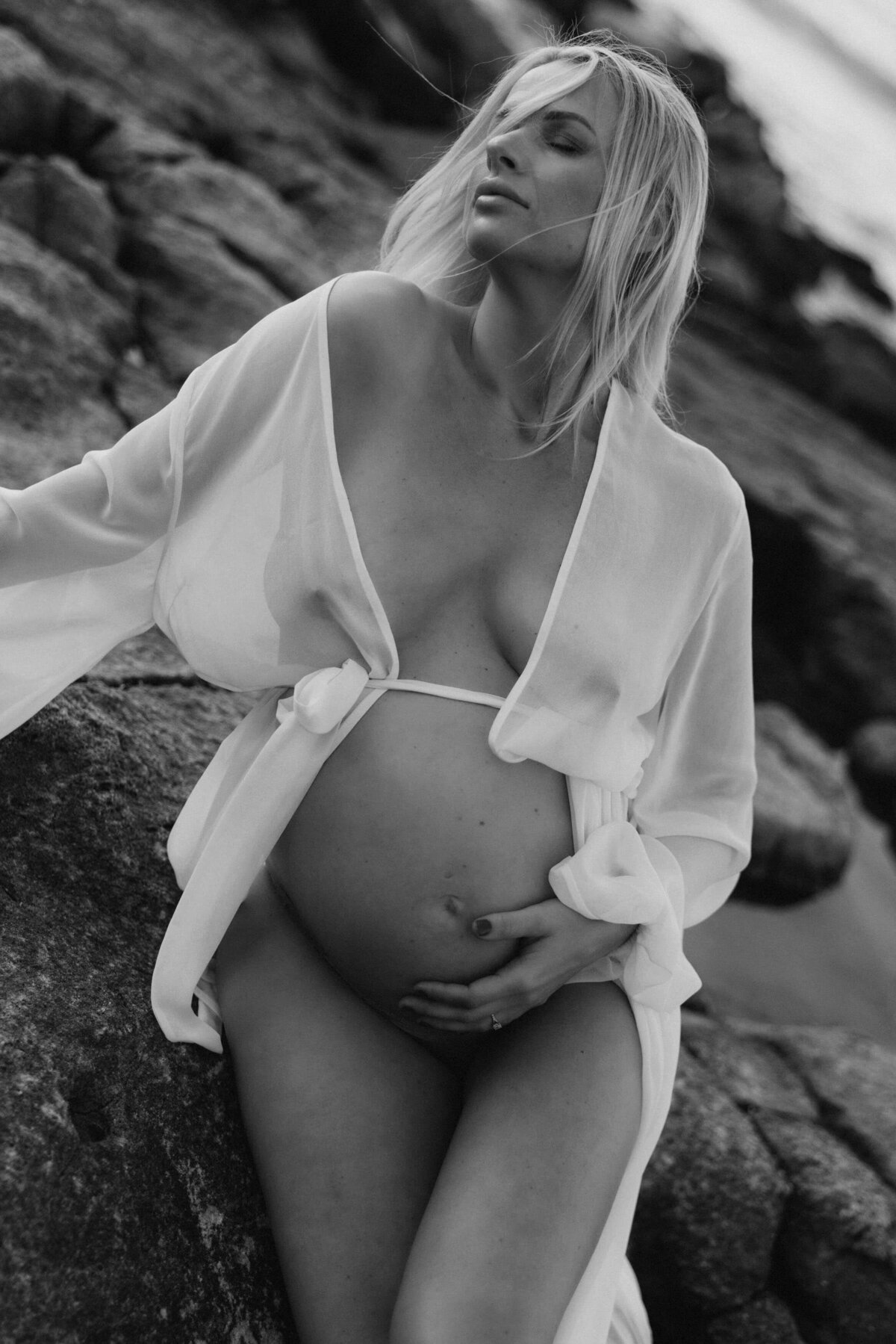 pregnant woman holding her bare belly