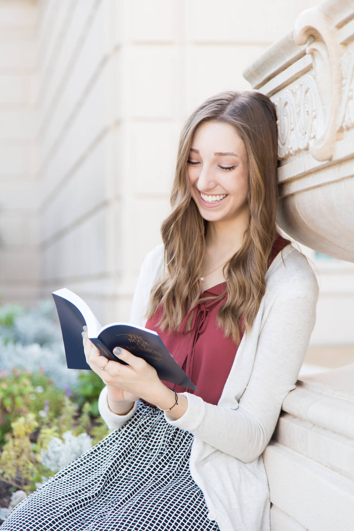 young woman reading a book of mormon