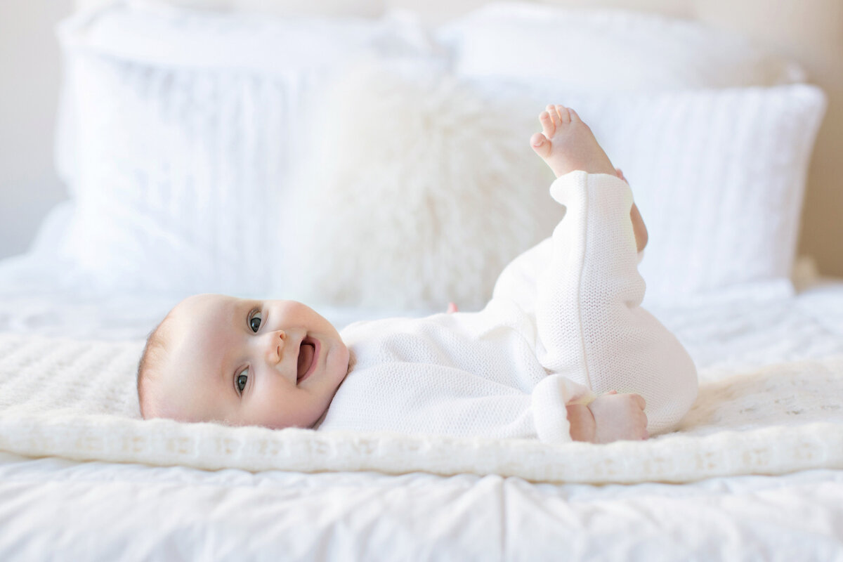 baby_in_white_on_bed