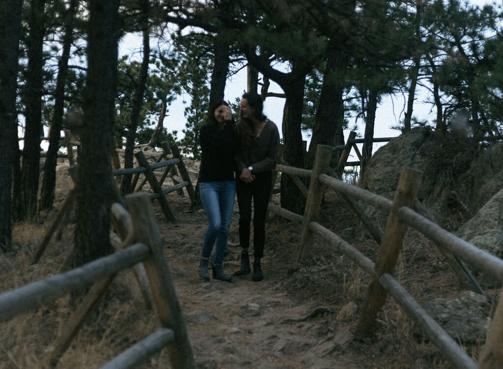 A couple holding hands and walking along a path.