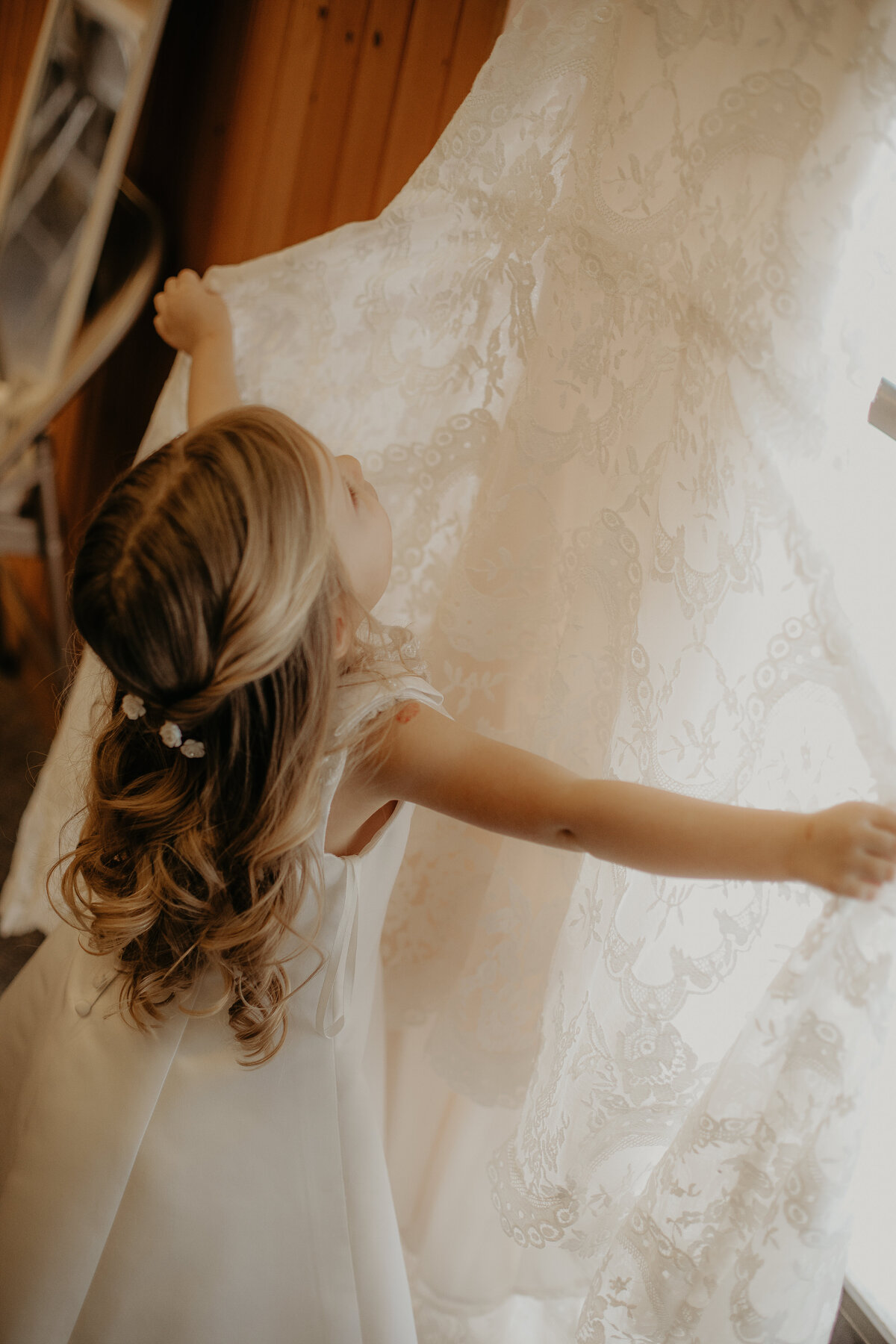 MINI BRIDE FLOWER GIRL DAUGHTER ADMIRING MOTHERS WEDDING GOWN