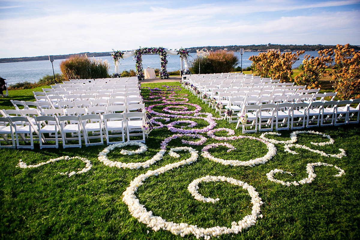 A beautiful purple and white floral design by Sayles Livingston for a ceremony at Oceancliff in Newport RI