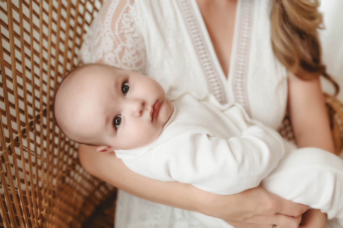 Mother embraces her baby during baby photoshoot in Charleston, SC.
