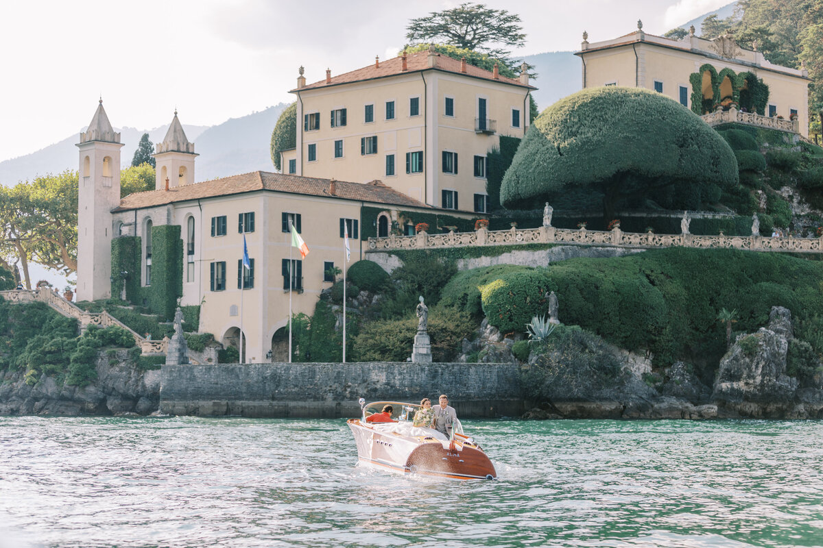 Bröllopspar i en Rivabåt utanför Villa Balbianello Como