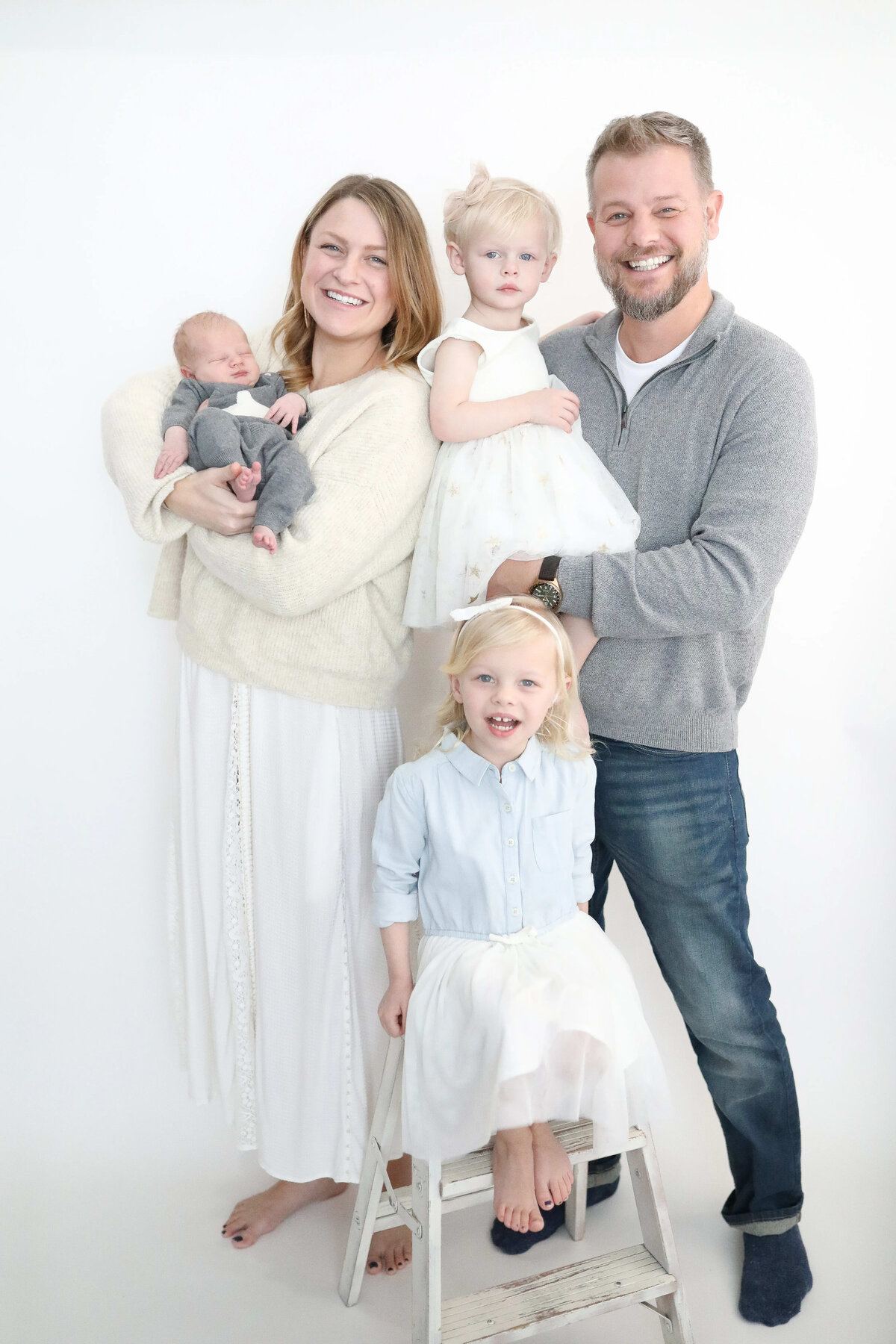 Family of five with newborn and two daughters in bright studio - Maple Grove family newborn session