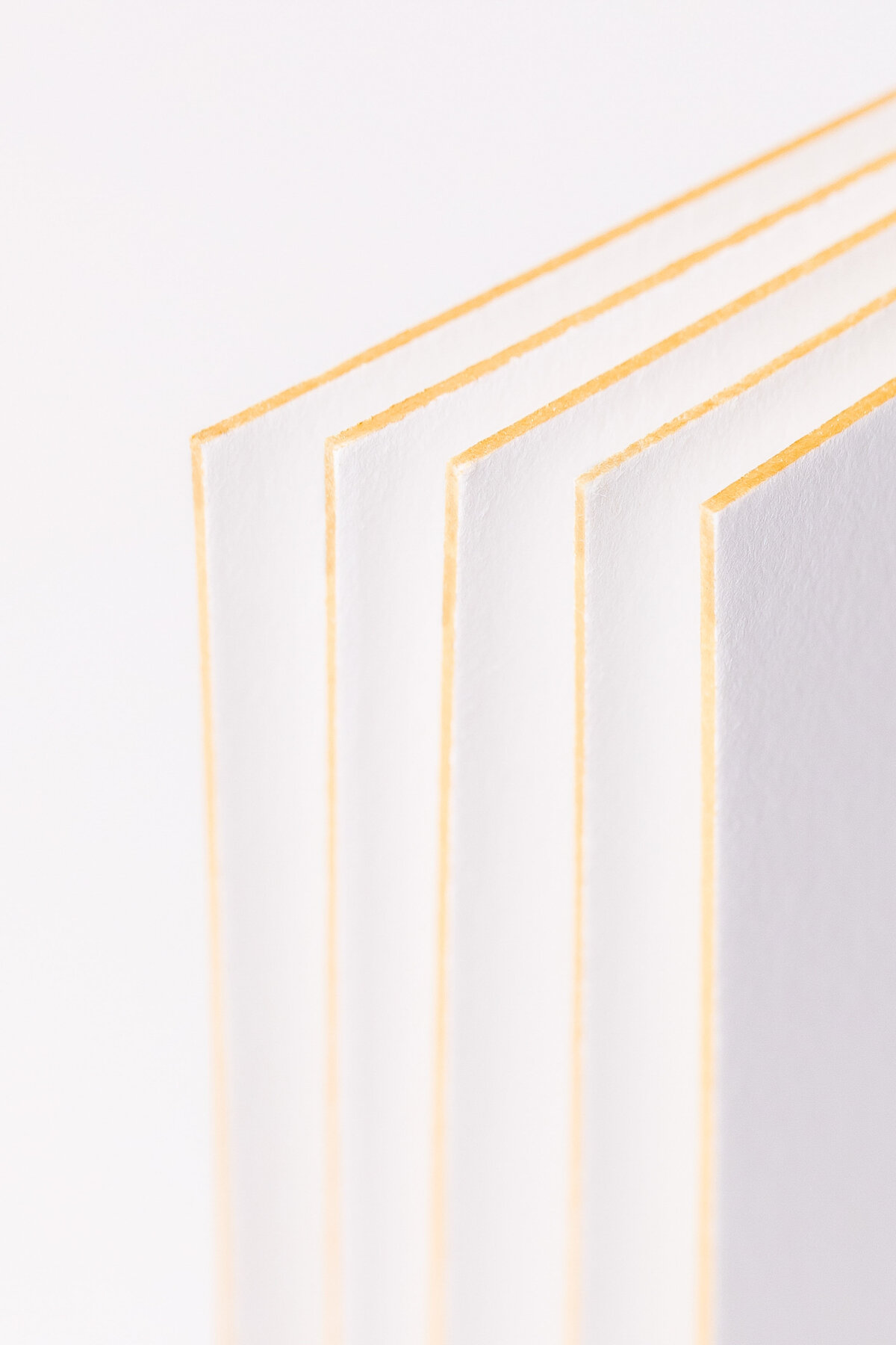 close up of paper with gold foil lined edges