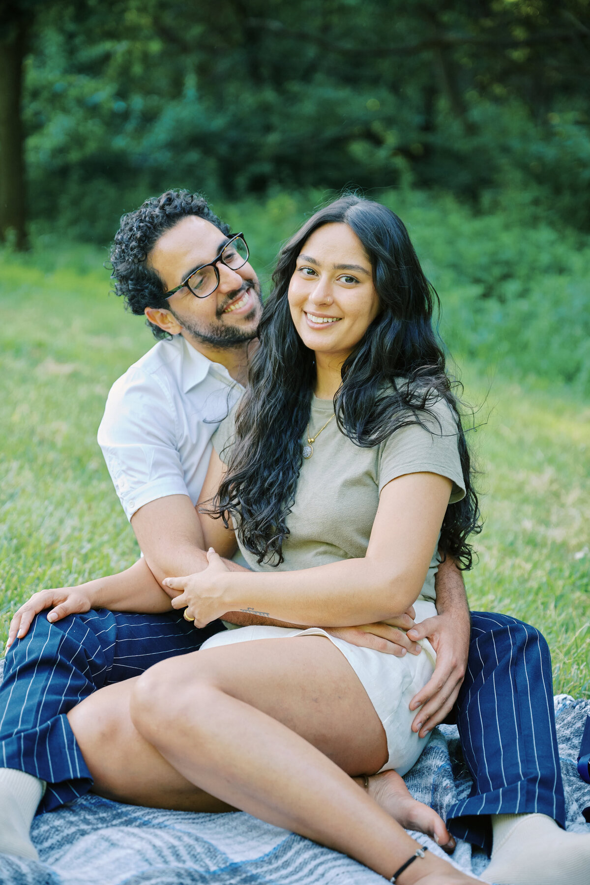 A couple sit together happily  after a successful NYC Picnic Proposal; New York City Proposal Photographer, Corey Lamar Photography