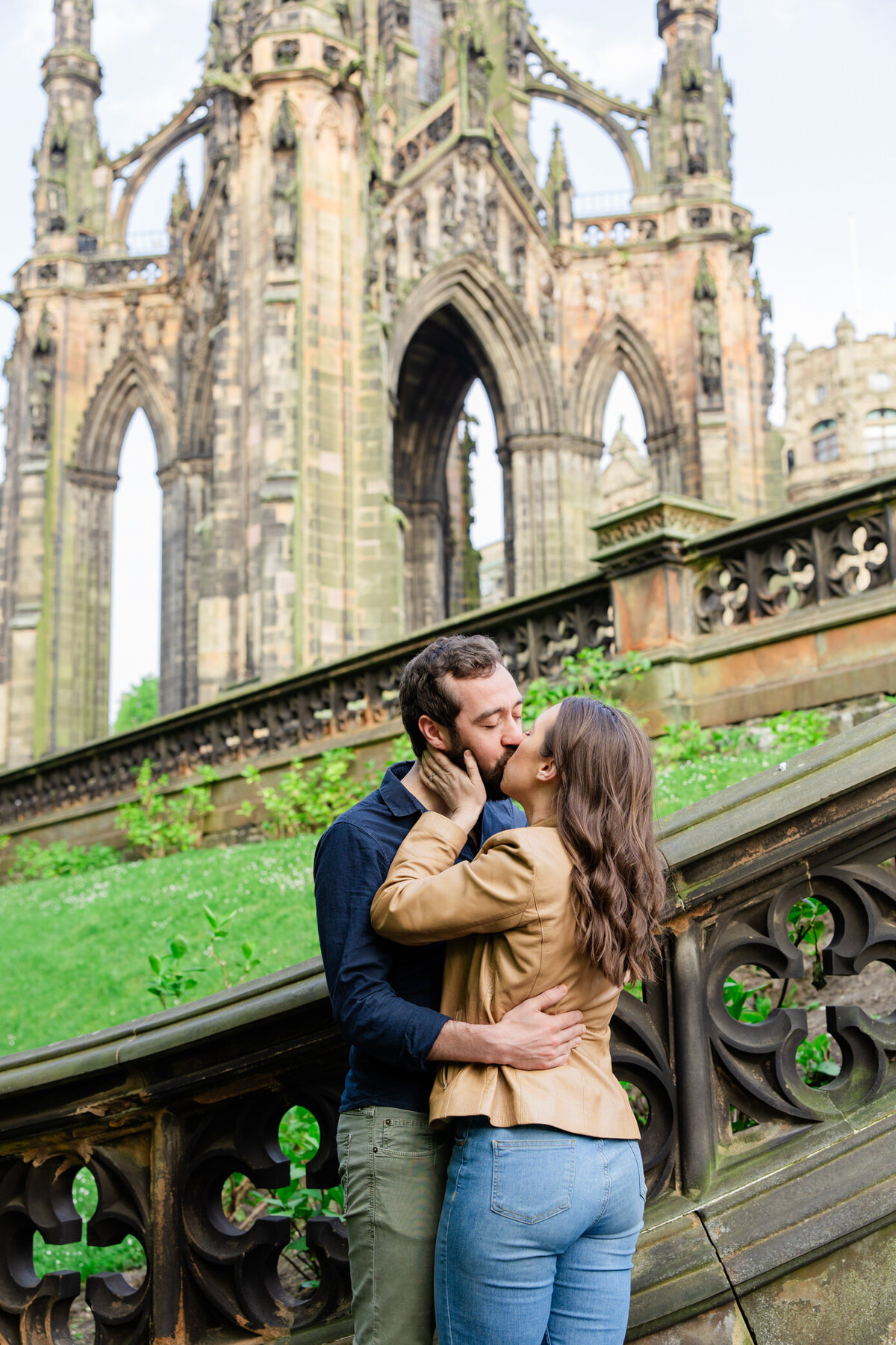 couple kisses in front of spire