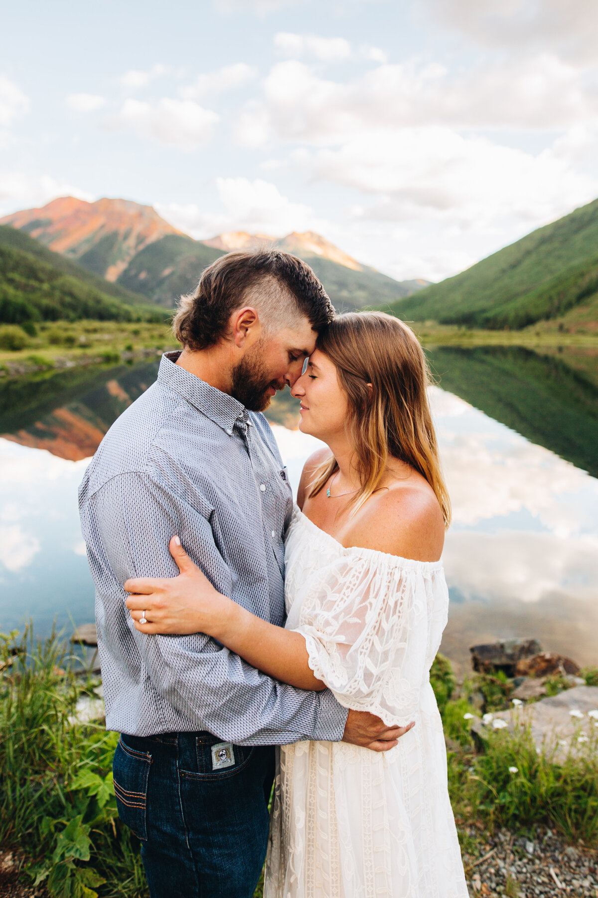 Ouray engagement session in front of a lake and Red Mountain.