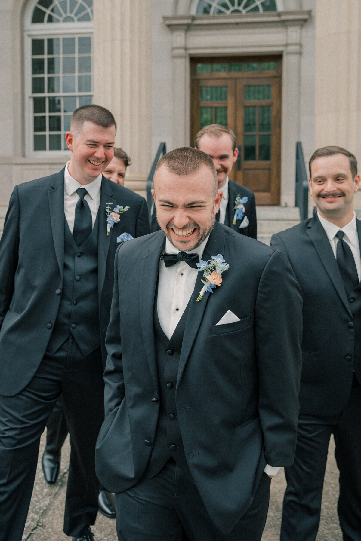 Candid moment of groom and groomsmen at the Bristol Train Station