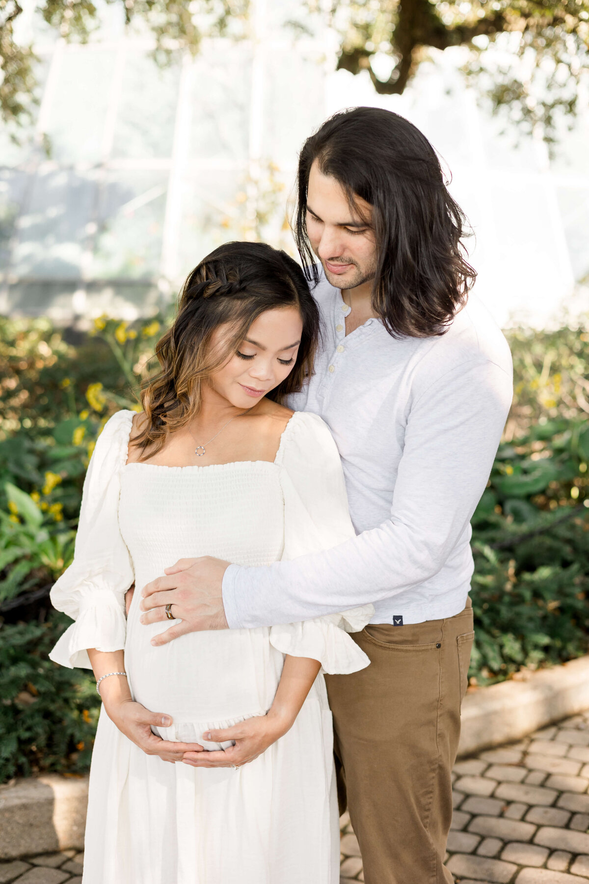 a man embracing his pregnant wife