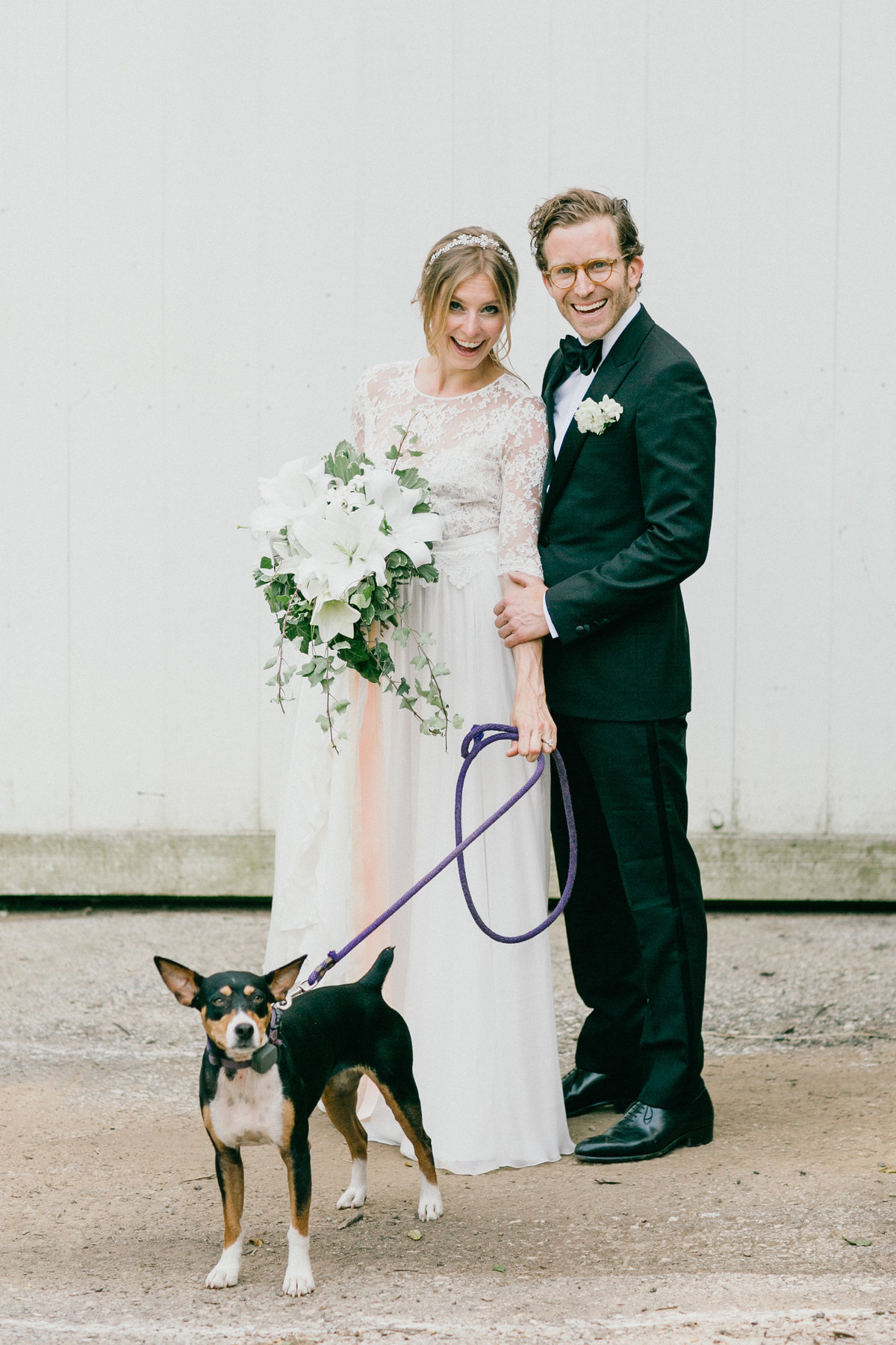 Family portrait of the bride, groom, and favorite furry friend.
