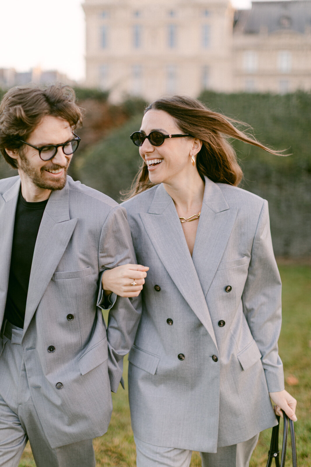 Engagement session at the Tuileries and Louvre in Paris, with a couple walking through the gardens under the morning light.