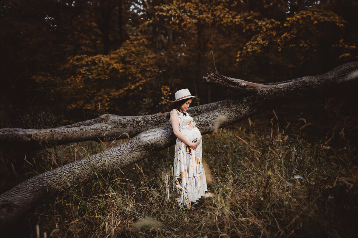 pregnancy photo with fallen tree