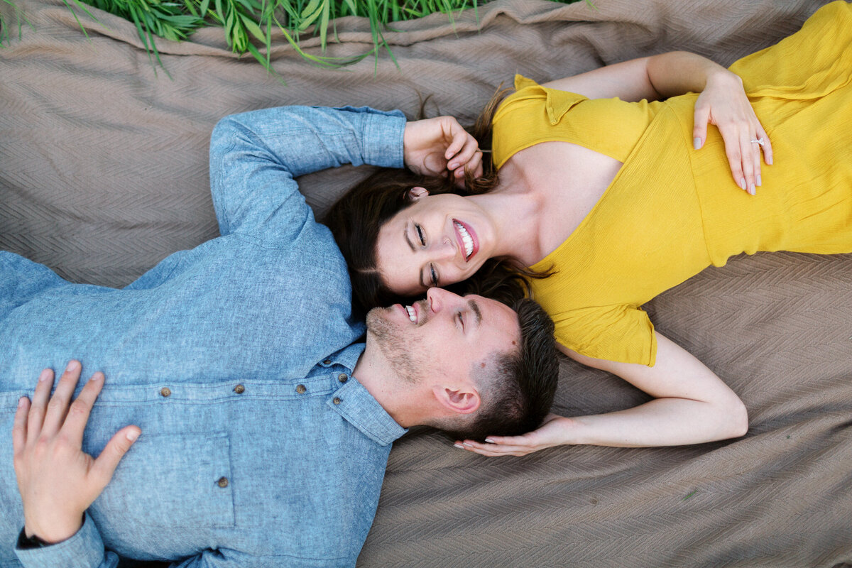 Couple laying in the fields of Maple Grove