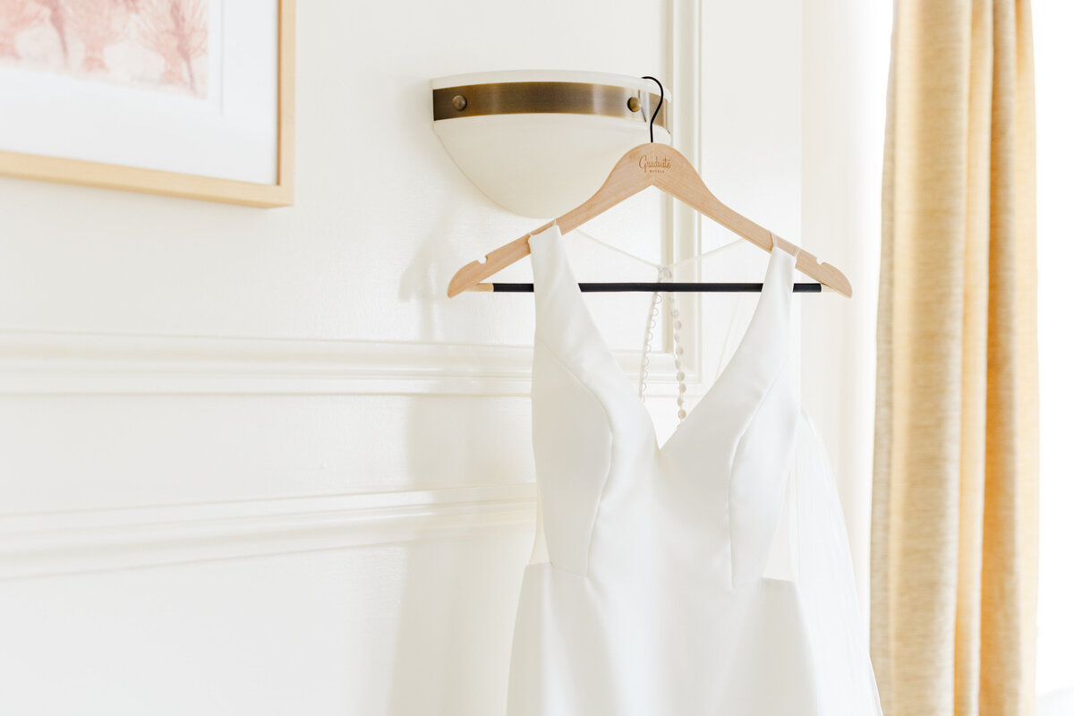 13_white_dress_hanging_on_hanger_in_getting_ready_suite