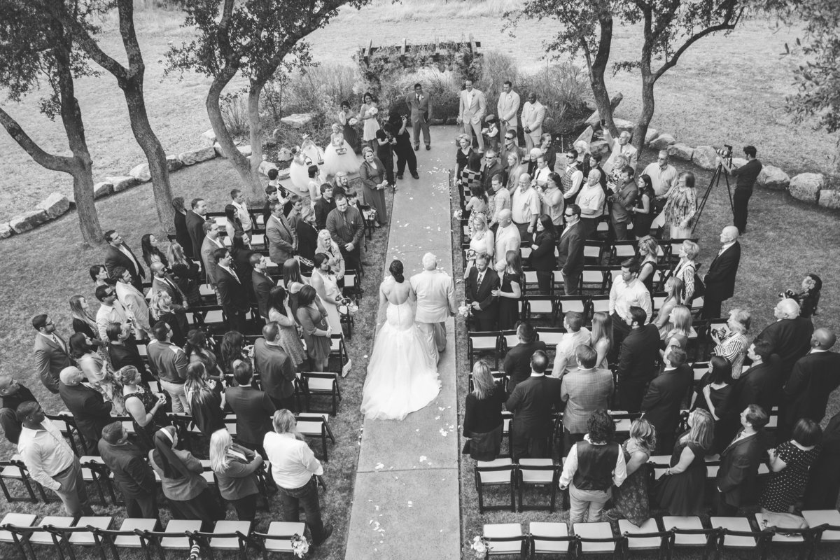 top view of father of bride walking daughter down aisle during wedding ceremony at Vista West Ranch venue in hill country