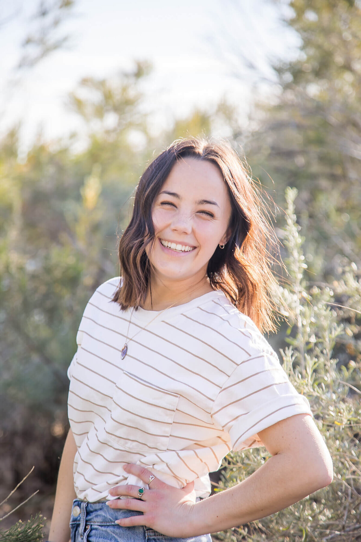 stunning happy dark haired girl smiling in desert park