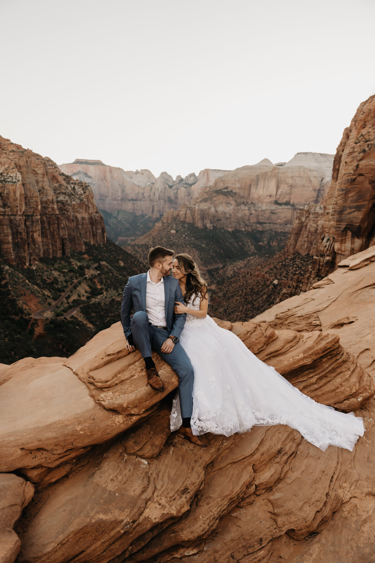 couple sitting on mountain top during elopement in arizona