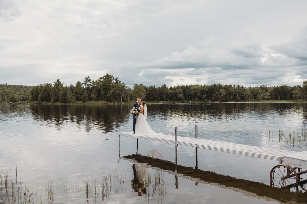 bride and groom embracing on dock