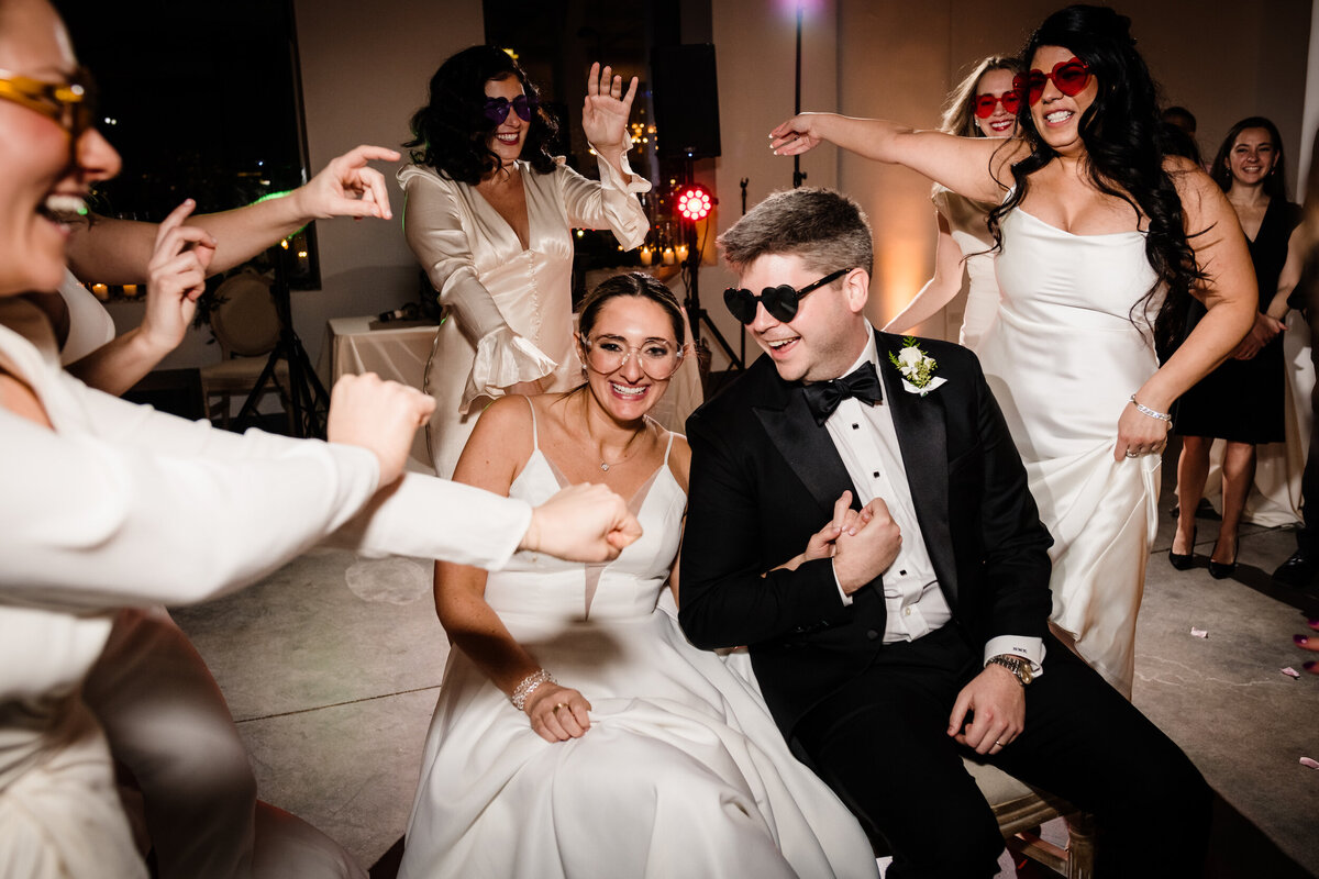 Wedding party dances for bride and groom on dance floor