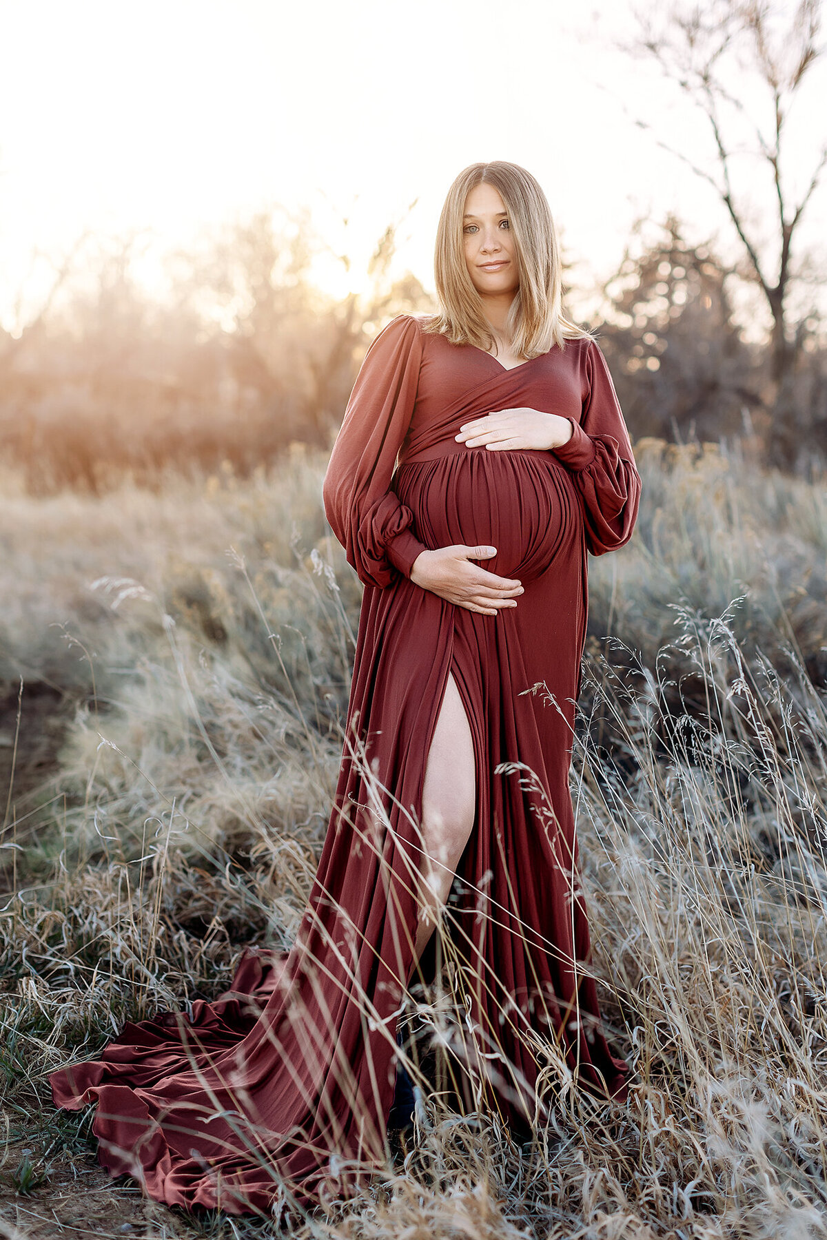 gorgeous mom in rose gown posing for her maternity photos in denver