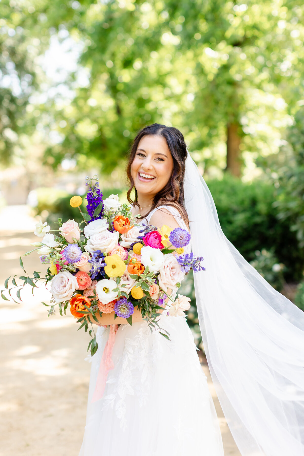 Bride smiling with beautiful flowers