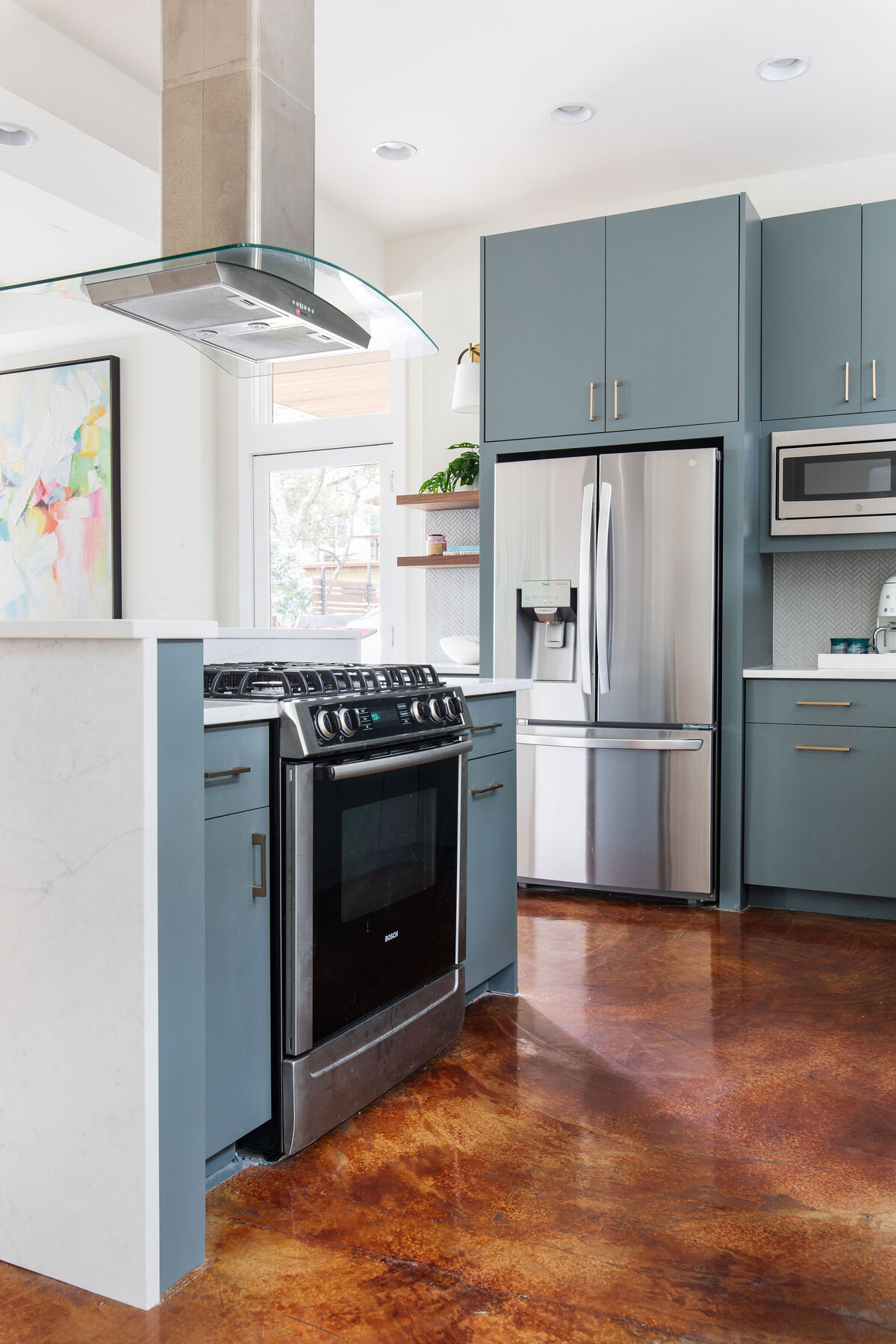 hello-home-Contemporary-Kitchen-Blue-Cabinets-Brass-Hardware-Stainless-Steel-Appliances-Polished-Concrete-Floor-Kitchen-Remodel-quartz-waterfall-island-Austin-TX-5