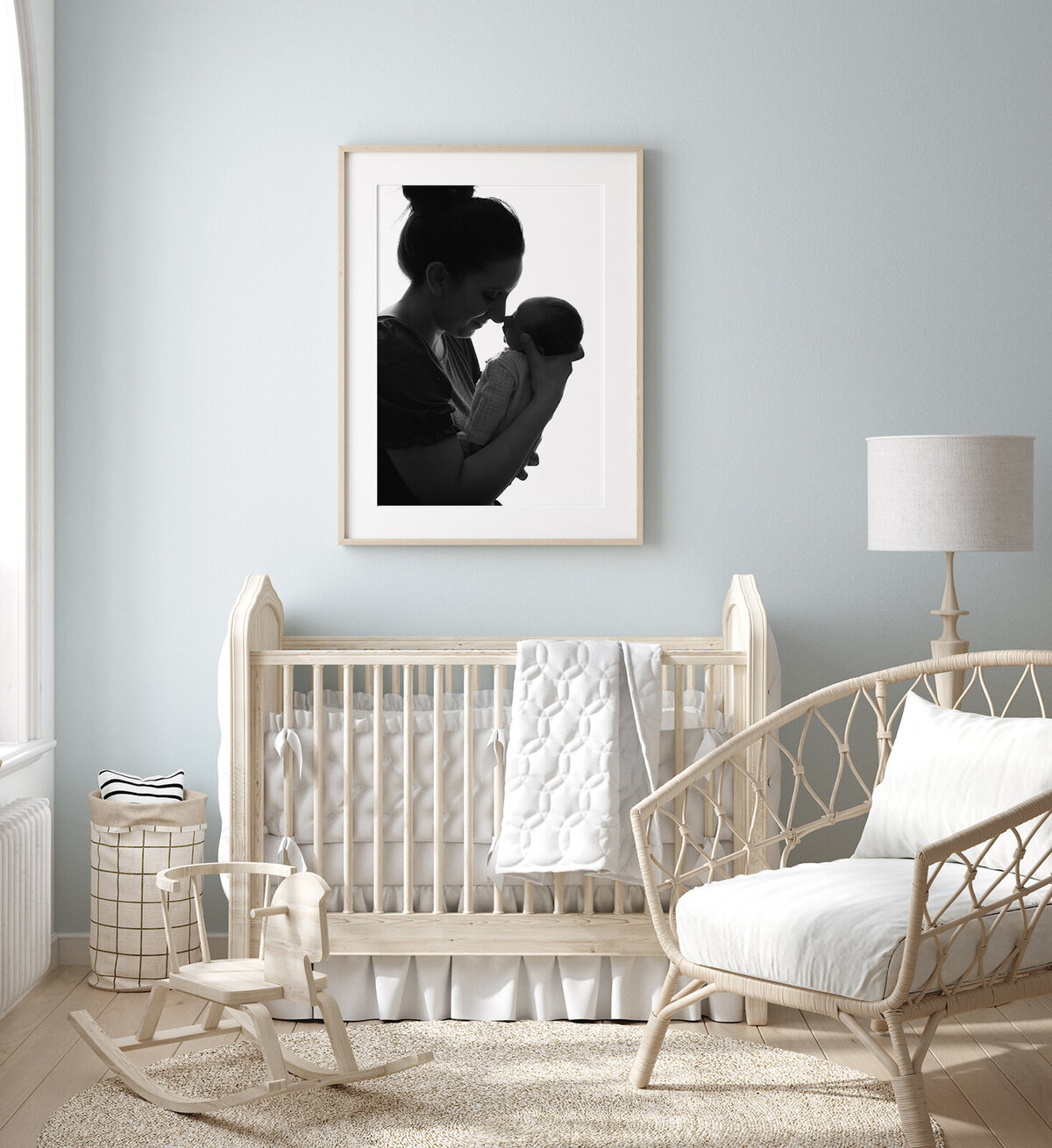 blue nursery with a framed print on the wall of a mom and her newborn baby by st. louis newborn photographer, sutherland photography