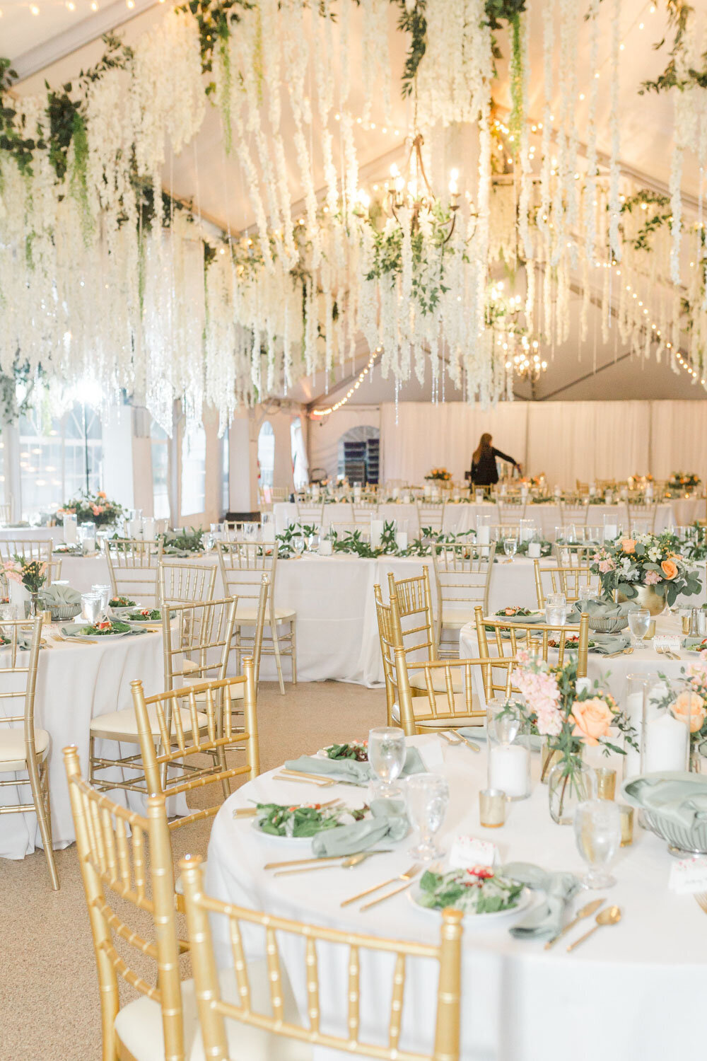 Indoor wedding reception with elegant designed tables and chairs