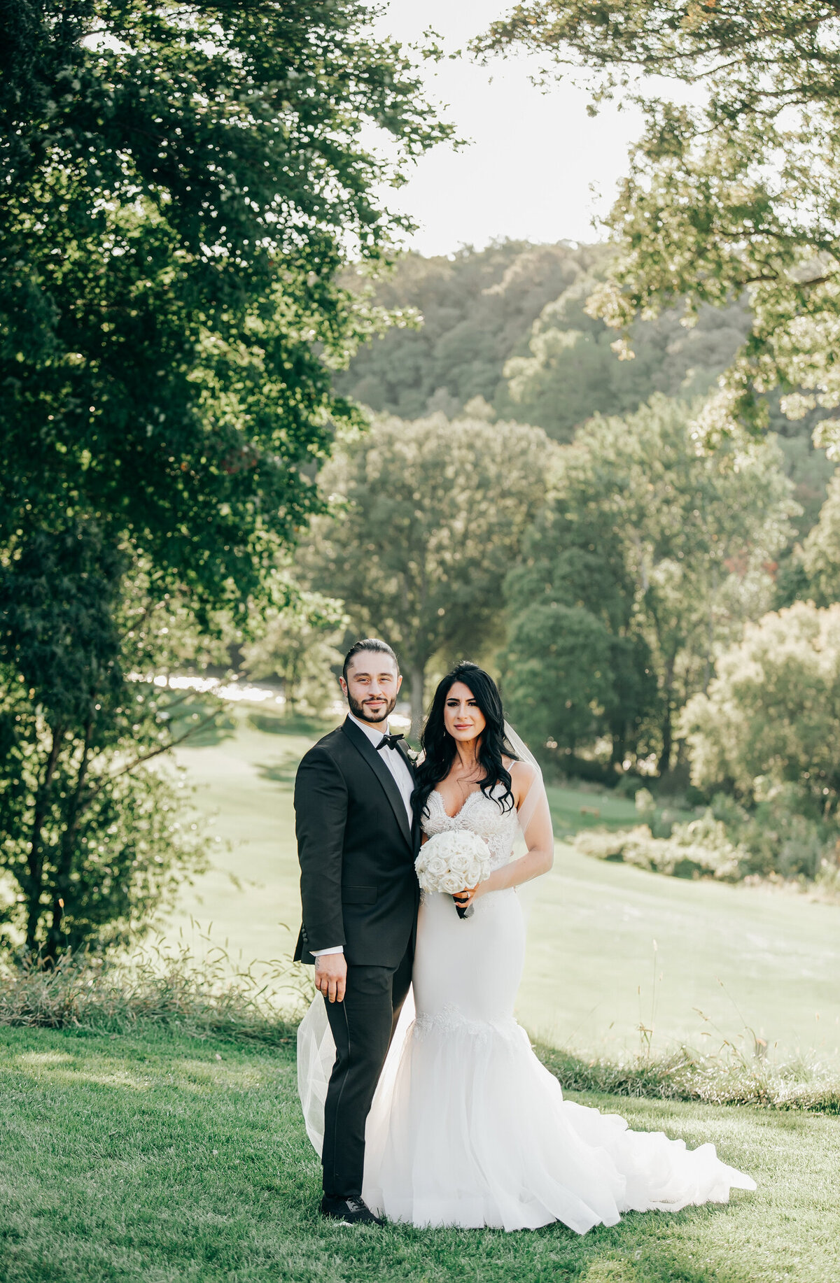 Elegant bride and groom posing for romantic photos on their Summer wedding day at London Hunt Club
