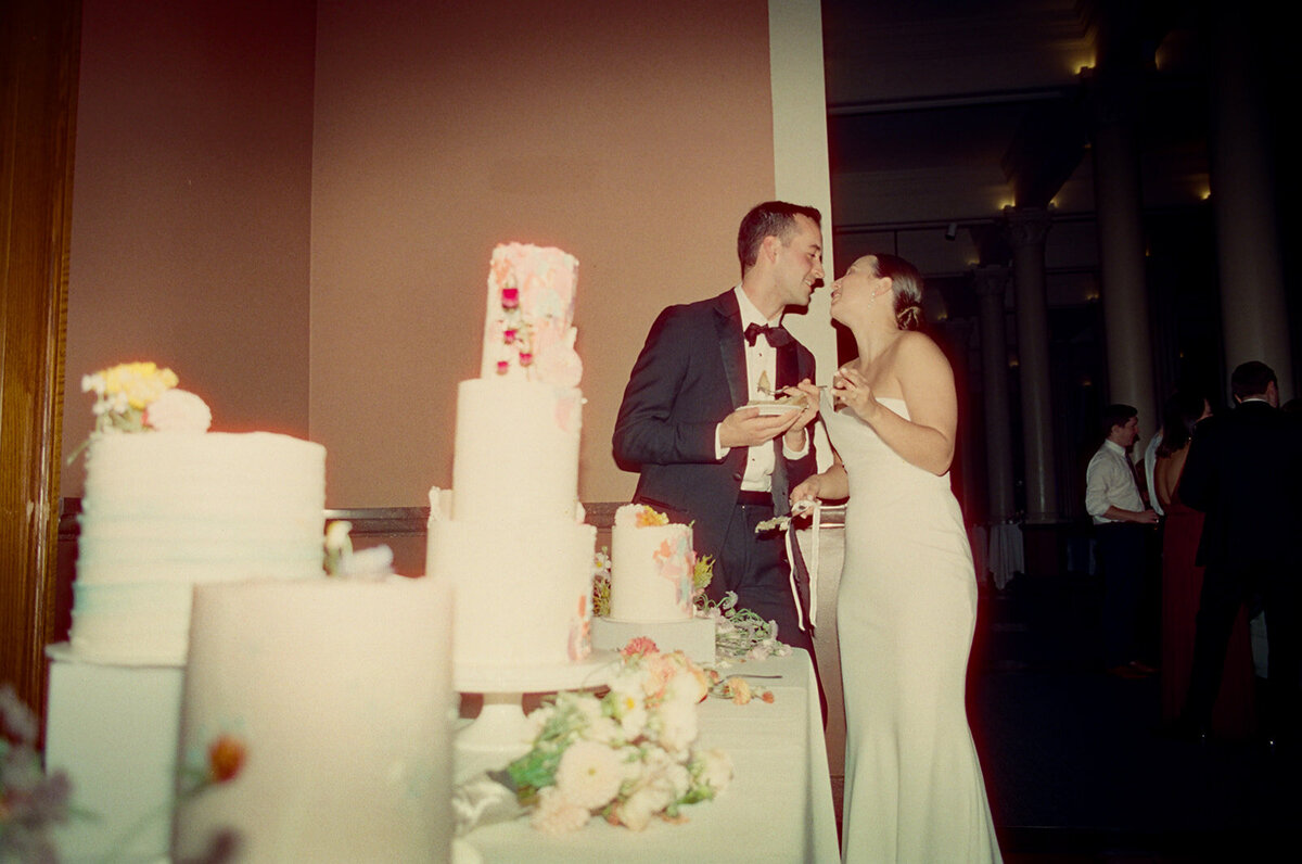 bride and groom cutting cake at their reception